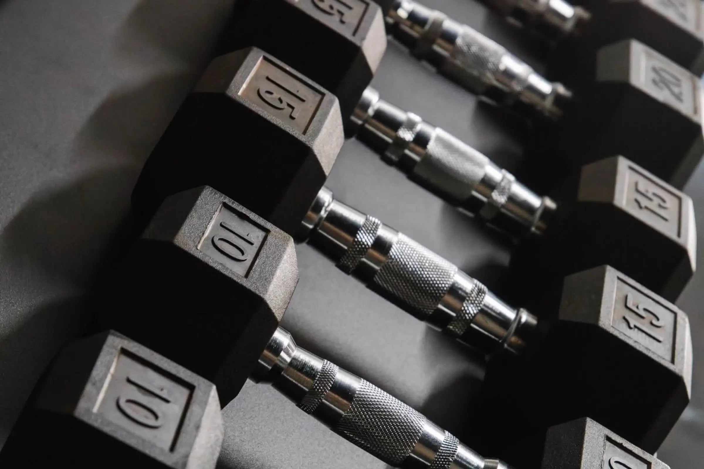 Close-up of hex dumbbell rack with weights ranging from 10 to 25 pounds