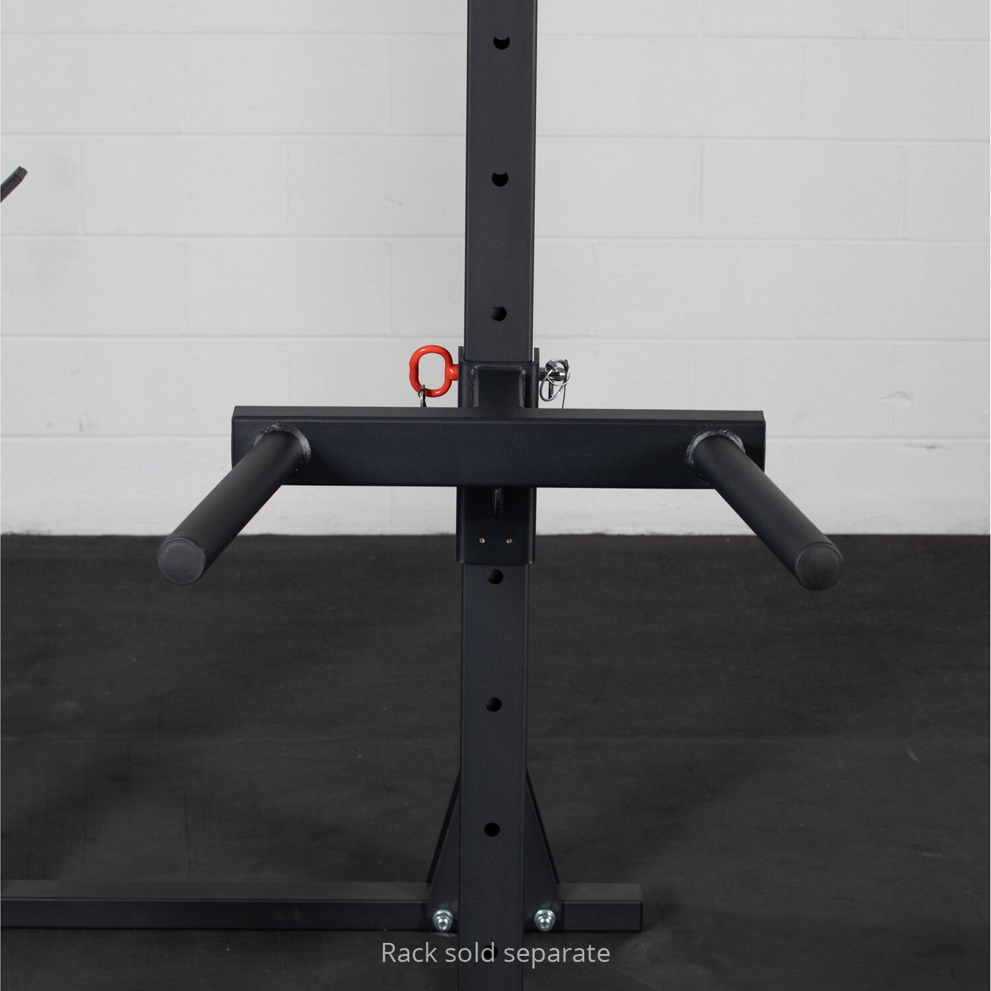 A black, sturdy Titan Fitness X-3 Series Y-Dip attachment with padded grips, highlighting a red lock, is mounted on a vertical post with a noticeable label indicating 'rack sold separately', set against - view 4