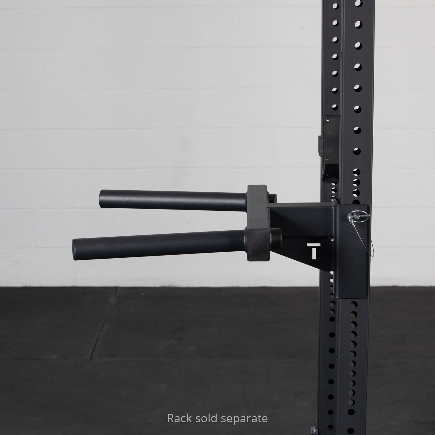 A sturdy black Titan Fitness X-3 Series Y-Dip bar attachment securely mounted to a squat rack with the noticeable label "rack sold separate," indicating the rack is not included with the dip station. - view 5