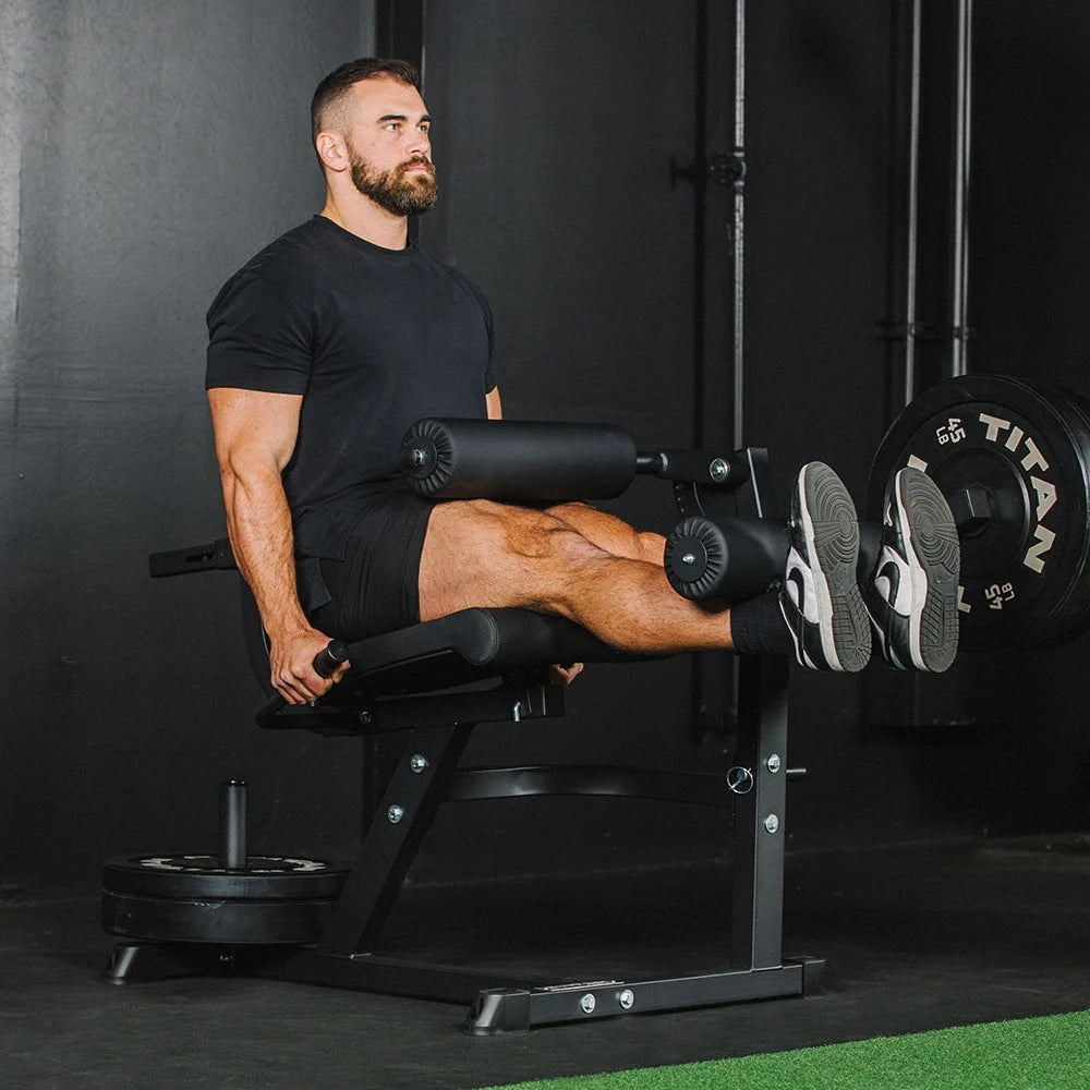 Titan plate-loaded leg extension and leg curl machine, curl extended - view 4