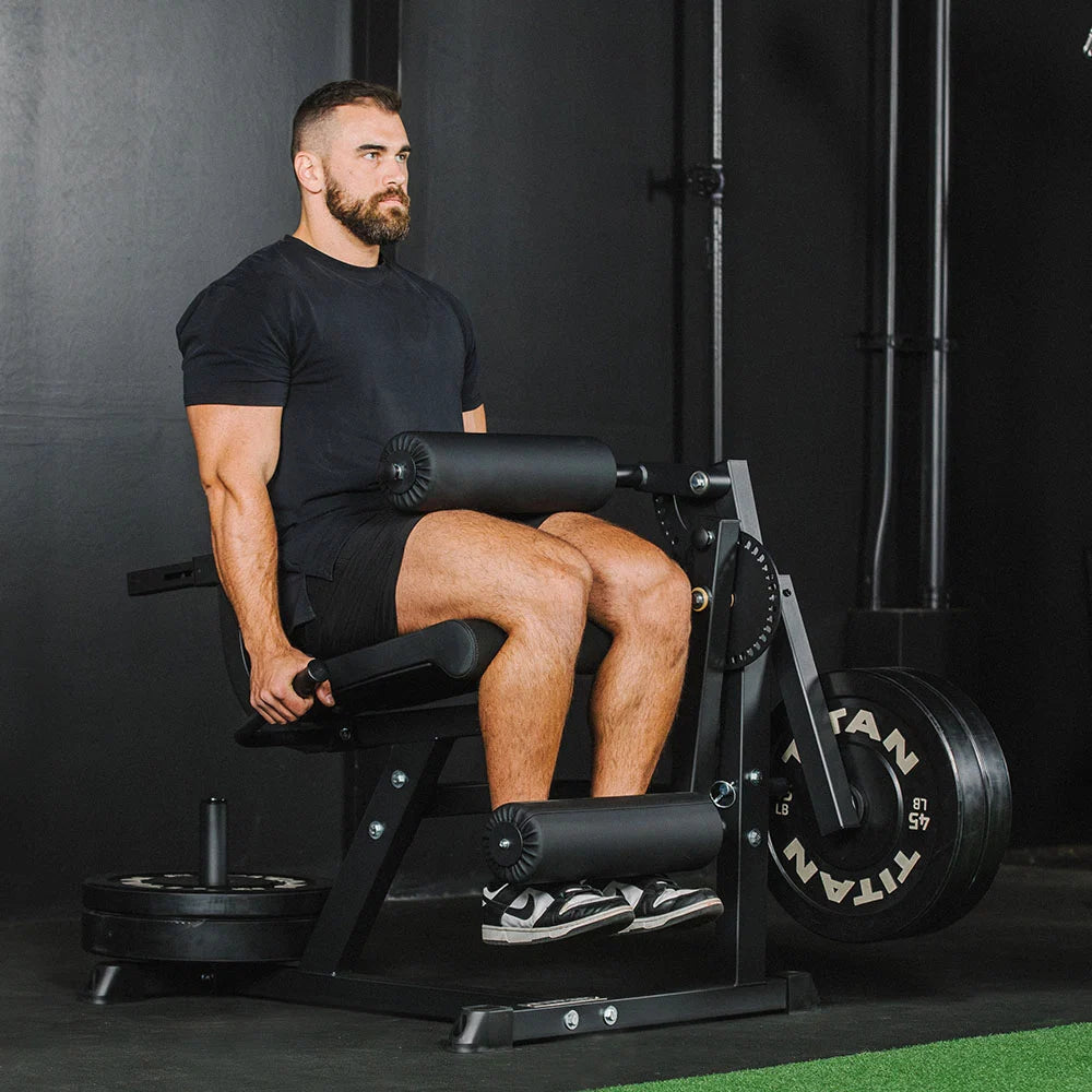Titan plate-loaded leg extension and leg curl machine, curl position flexed - view 2