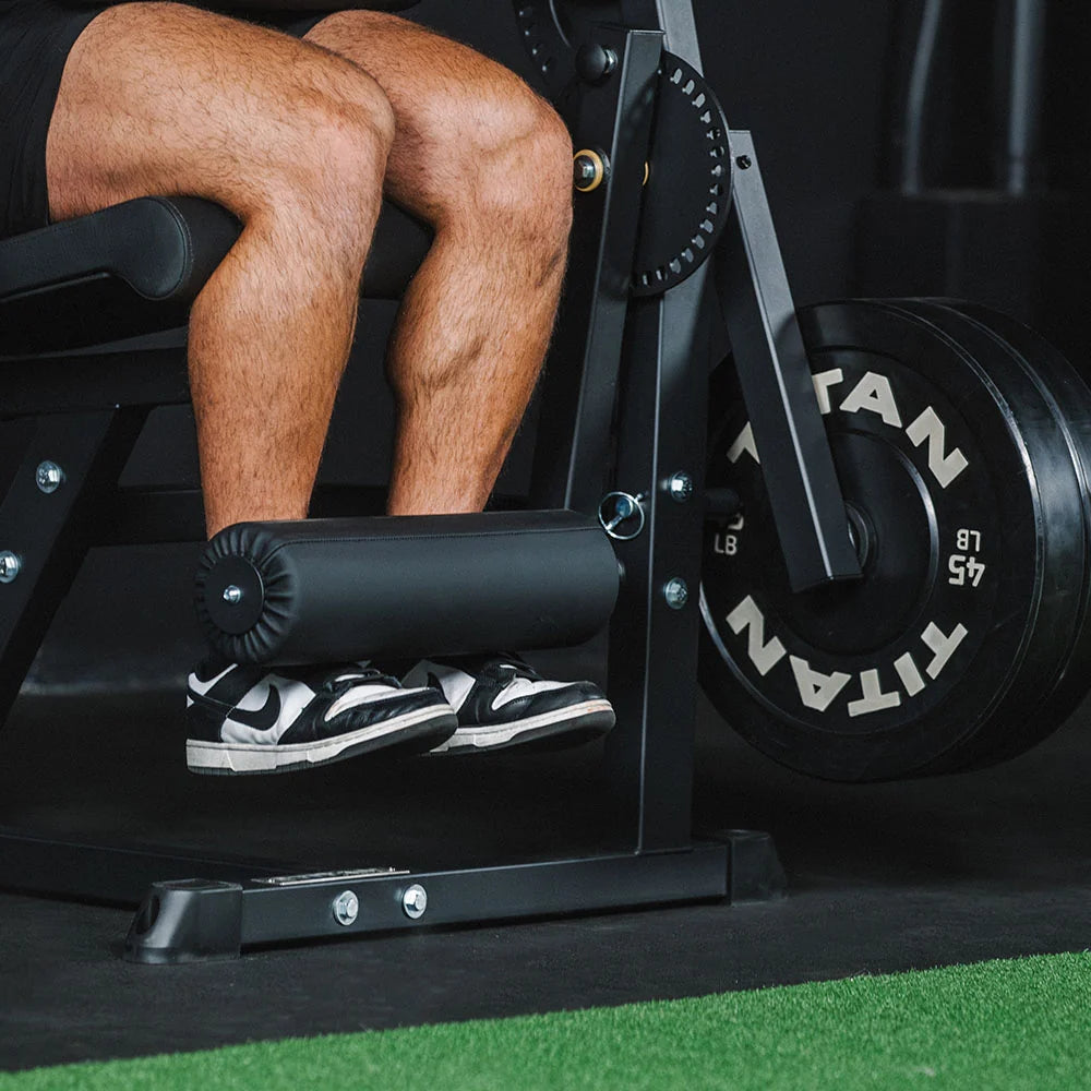Titan plate-loaded leg extension and leg curl machine, padded foot roller and weights - view 3